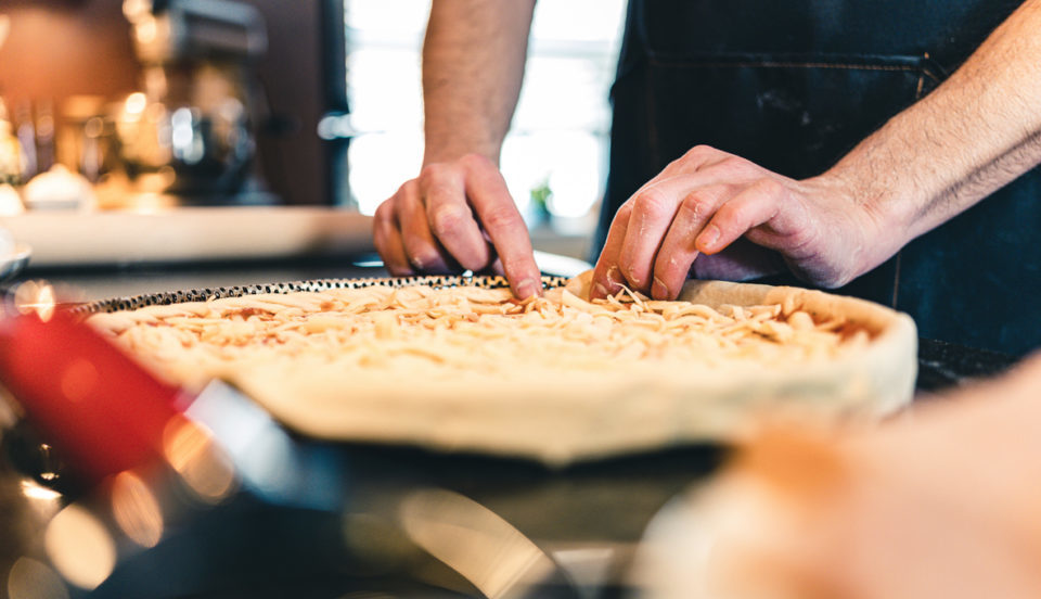 Hands of Man making pizza