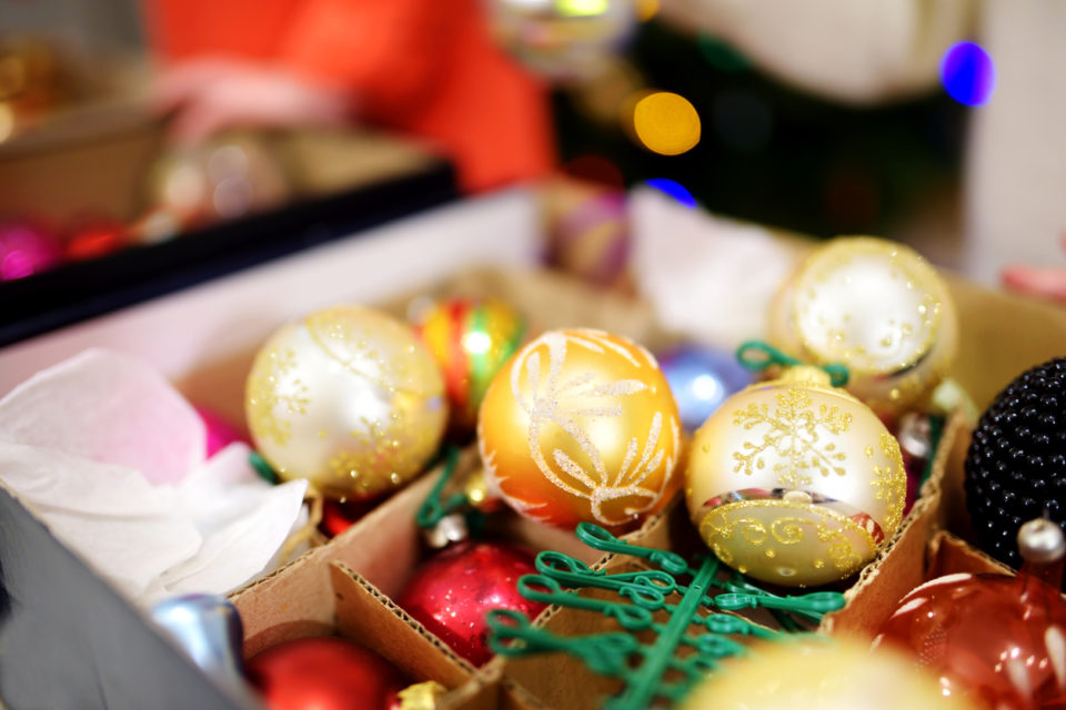 Various colorful Christmas decorations in boxes