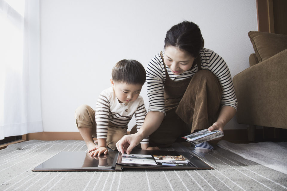 Mother and son making a photo album together