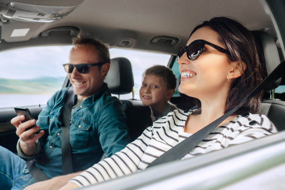 Happy family traveling in car