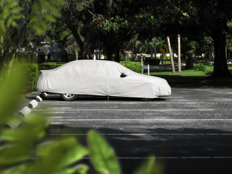 Covered car in parking lot