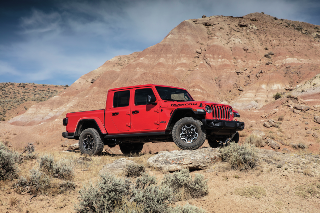 red Gladiator truck on rocky terrain