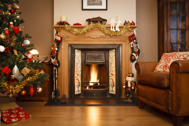 Decorated fireplace in a family home with Christmas tree