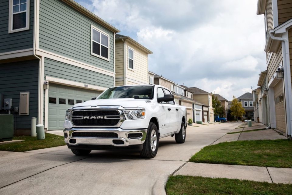 white RAM truck in driveway on cloudy day